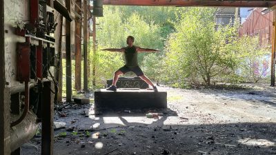 Dantes Yoga - Dante Harker doing yoga in a factory setting